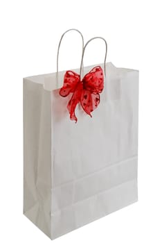 White paper gift bag with red sparkly ribbon isolated on white background