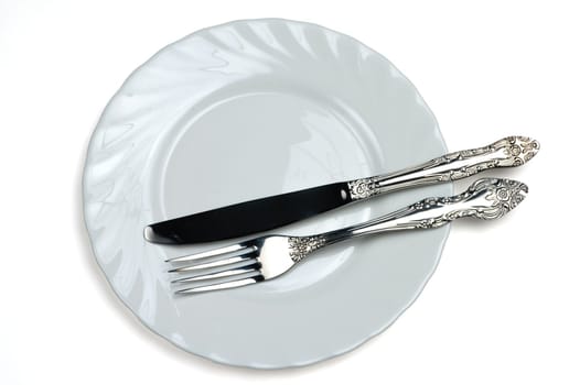 Knife and fork on a white plate