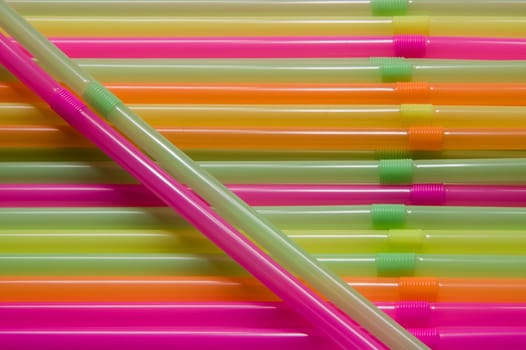 Many multi-coloured straws for juice