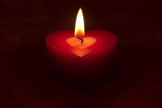 Romantic heart shaped candle and candlelight