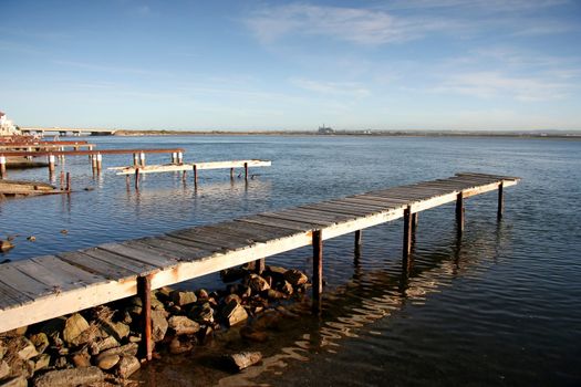 Old delapidated jetties on a river estuary