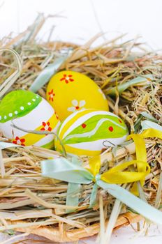 Closeup basket with colorful Easter Eggs isolated in studio