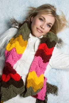 Beautiful woman laying in snow