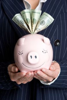 Business woman holding piggy bank