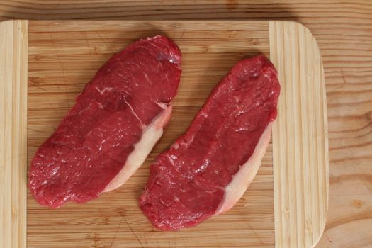 a rare rump steak is getting prepared