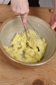 preparing creamy mashed potatoes in a  bowl