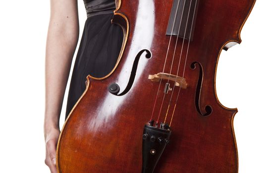 Woman in black dress holding violoncello in hand