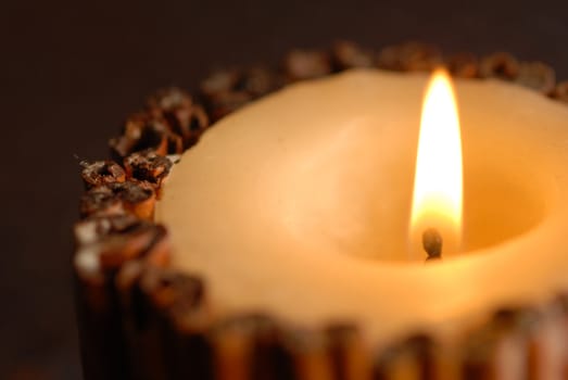 natural candle lit decorated with cinnamon sticks
