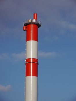 red and white chimney against a blue sky