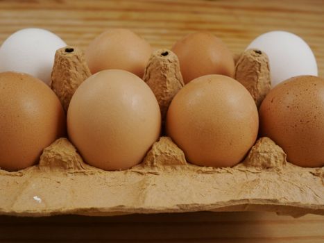 brown eggs on a wooden surface indoor