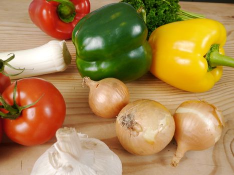 many different vegetables on a wooden table