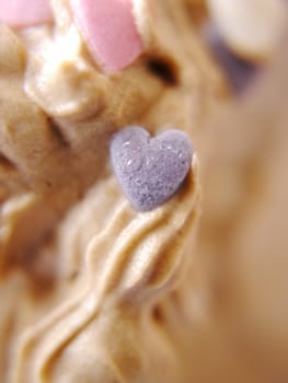 blank candy heart on a cake pink heart is in focus