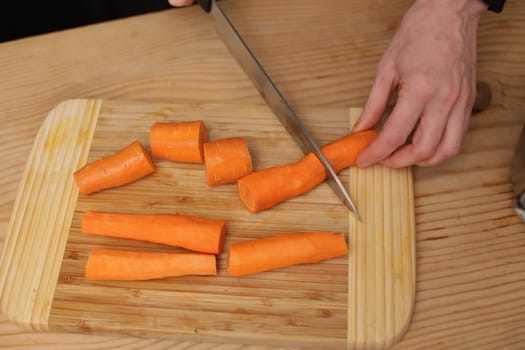 fresh carrots on a wood table in an oblique view