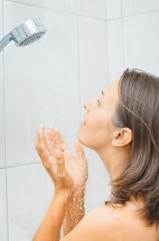 Young beautiful smile woman in shower enjoy