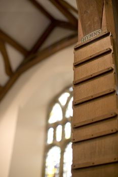 blank wooden hymn board in a gothic style church