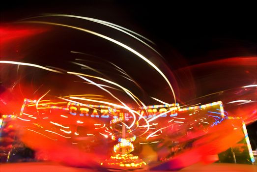 Blur neon lights in amusement park, long exposure