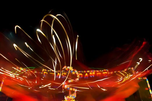 Blur neon lights in amusement park, long exposure