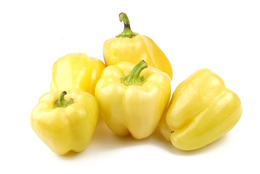 Group of yellow peppers on white background