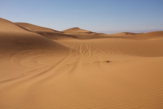 Sahara desert close to Merzouga in Morocco with blue sky and clouds