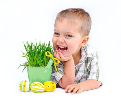 Easter egg hunt. Cute little boy with Easter eggs and basket the green spring grass Isolated on white background