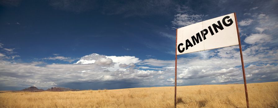 Camping signboard in the de desert of Namibia