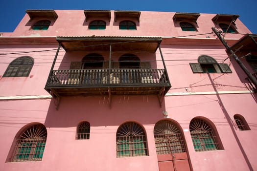 The pink house in saint-louis with a blue sky