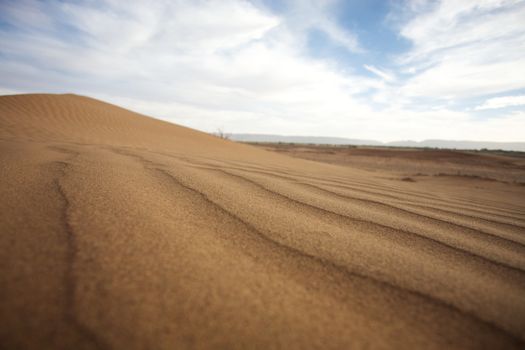 Sahara desert close to Merzouga in Morocco with blue sky and clouds