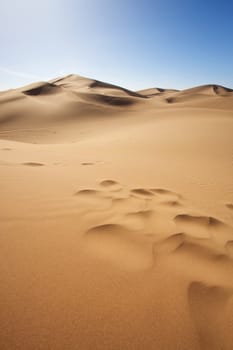 Sahara desert close to Merzouga in Morocco with blue sky and clouds