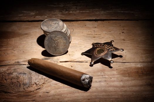 Cigar, badge  and pile of old silver coins