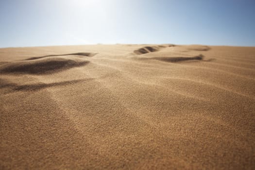 Sahara desert close to Merzouga in Morocco with blue sky and clouds