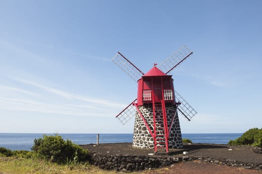 Red windmill in the coast of Pico island, Azores