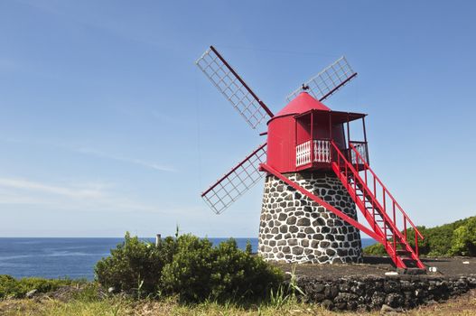 Red windmill in the coast of Pico island, Azores