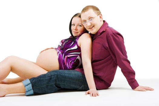 happy young couple on a white background. Pregnancy

