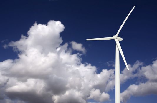 Single Wind Turbine Over Dramatic Blue Sky and Clouds.