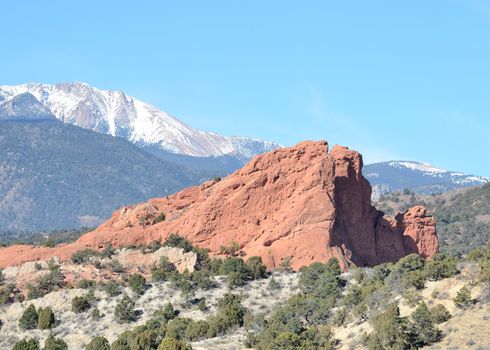 Scenic view of South Gateway Rock rock formation at Garden Of The Gods Park outside of Colorado Springs, Colorado with Pikes Peak behind.