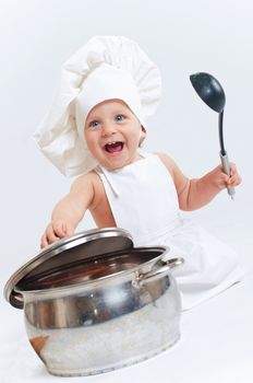 Little cook. Cute little boy in a suit of Food Boy with kitchen accessories. In the studio