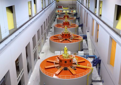 A lineup of large turbines generating electricity power on the Columbia river for Washington Oregon states.