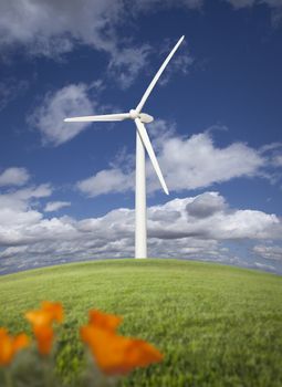 Wind Turbine Against Dramatic Sky, Clouds and California Poppies in the Foreground.
