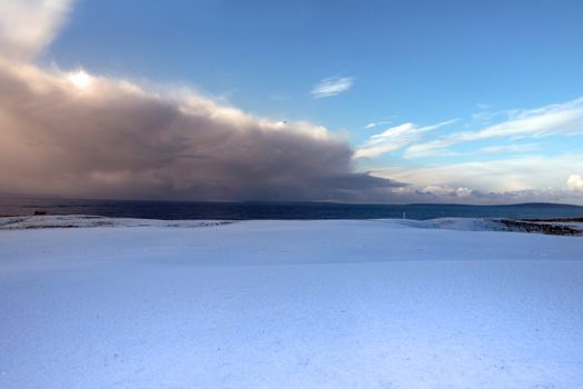 a snow covered links golf course in ireland in stormy winter weather