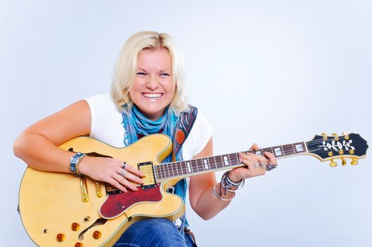 Young beautiful country music guitar girl smiling