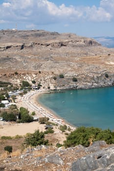 View from above of Lindos Main Beach in Rhodes, one of the Dodecanese Islands in the Aegean Sea, Greece.