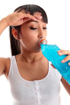 An exausted young girl drinking a sports drink after exercise workout.  White backgound.