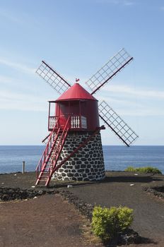 Red windmill in the coast of Pico island, Azores