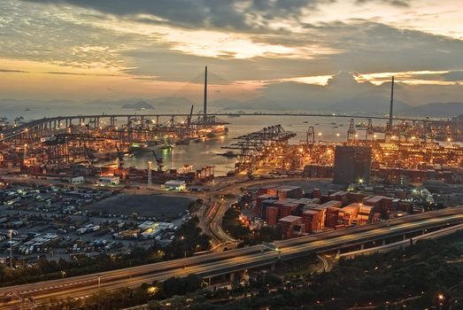 Port warehouse with cargoes and containers at night 