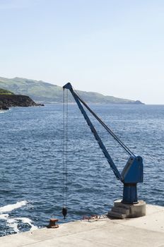 Port crane in a small harbor, Pico, Azores