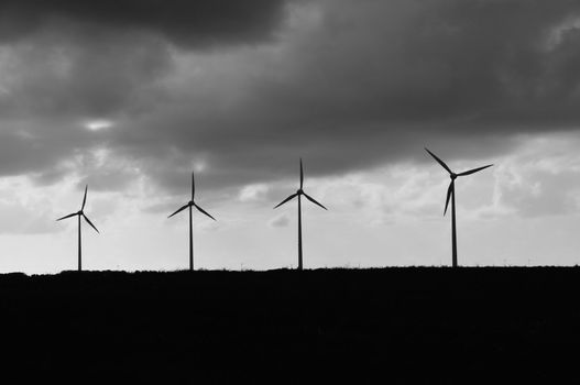 Wind mills on stormy day in brittany, france