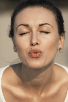 Pretty young caucasian girl sending kiss