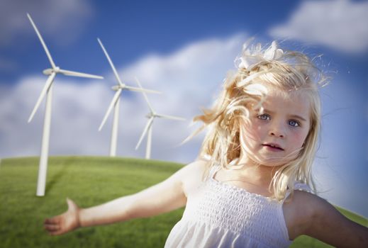 Beautiful Young Girl Playing Near Wind Turbines and Grass Field.