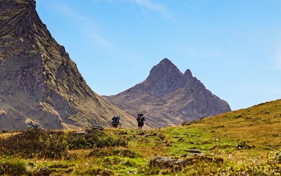 Image of two hikers walking in Pyrenees Mountains,France.