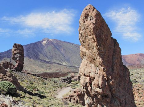Roques de Garcia, with volcano in the background, in Teide National Park, Tenerife, Canary Islands, Spain .The conical volcano Mount Teide or El Teide in Tenerife is Spain's highest mountain.